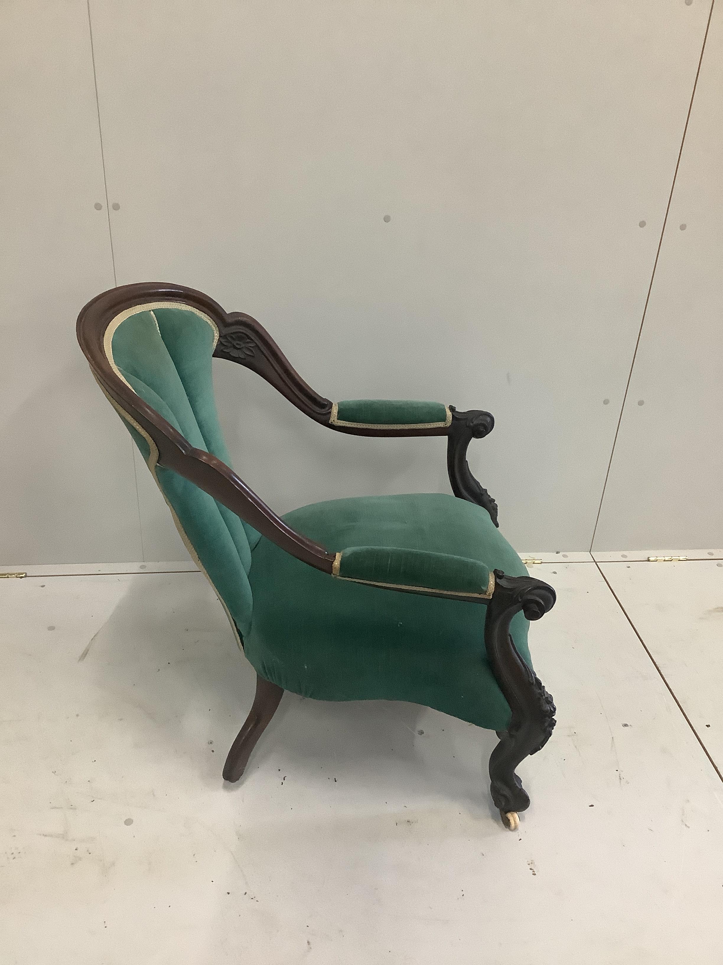 A Victorian carved mahogany open frame armchair